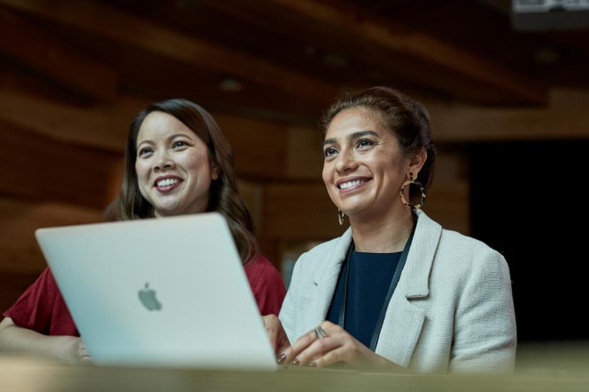 Two female postgraduate UTS students with apple laptop