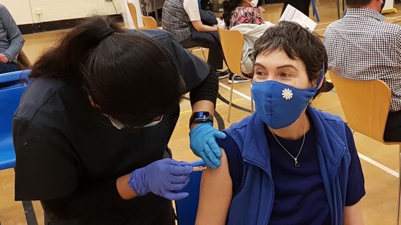 woman receives vaccination