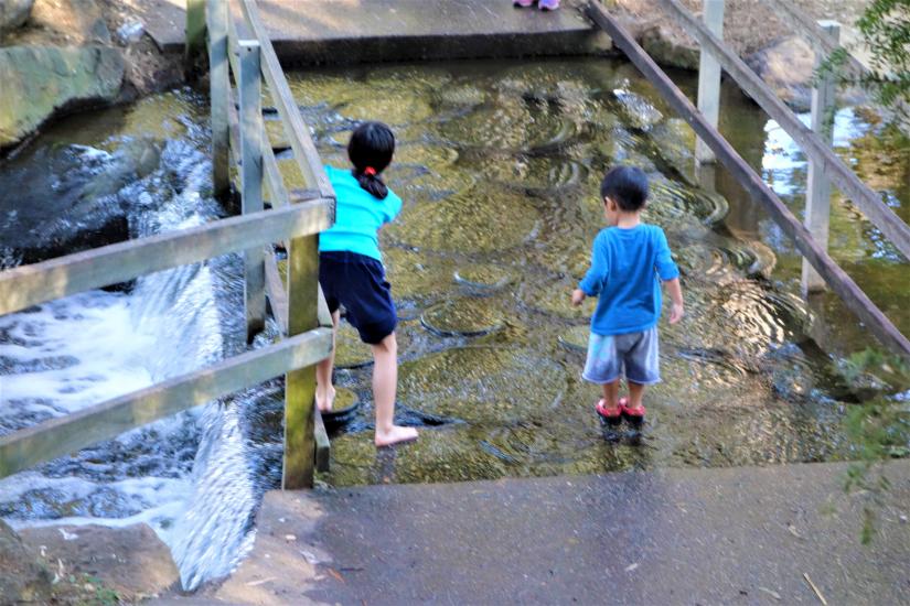 Children playing in waterfall feature
