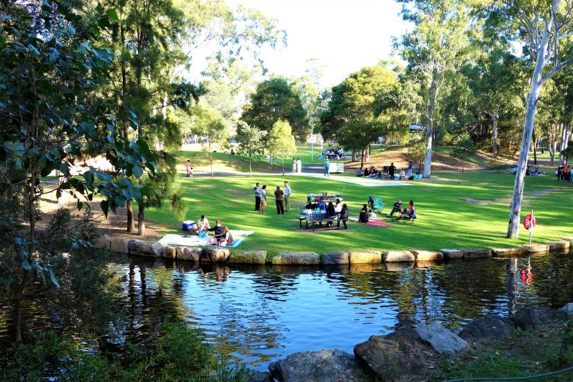 Park scene: picnic, green grass, lake 