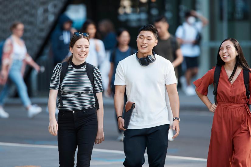 Three students walking together outside UTS campus