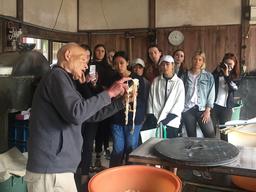 Ichibei Iwano explains the art of making traditional Japanese paper to watching students