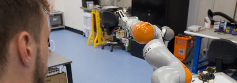 A researcher sends commands to a robot.