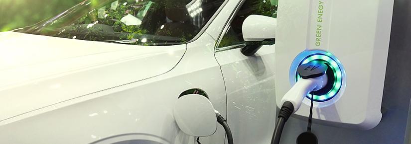 An electric car is connected to a charging point