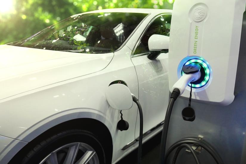An electric car is connected to a charging point