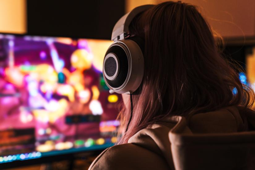 Girl in headphones playing a video game