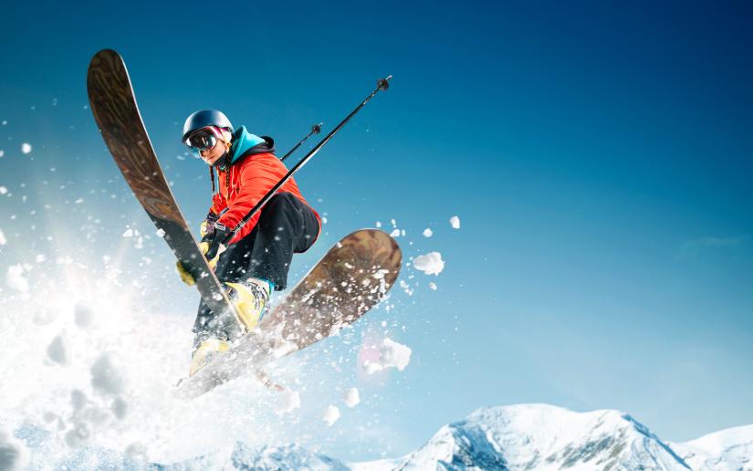 a skiier jumps on a mountain