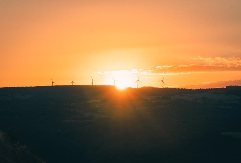 Wind turbines on a hill at sunrise