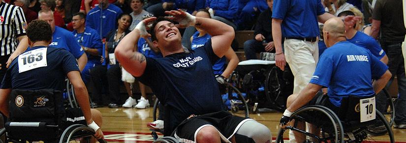 Amputee in Navy Coast Guard wheelchair baskbetball team displays exasperation on the court