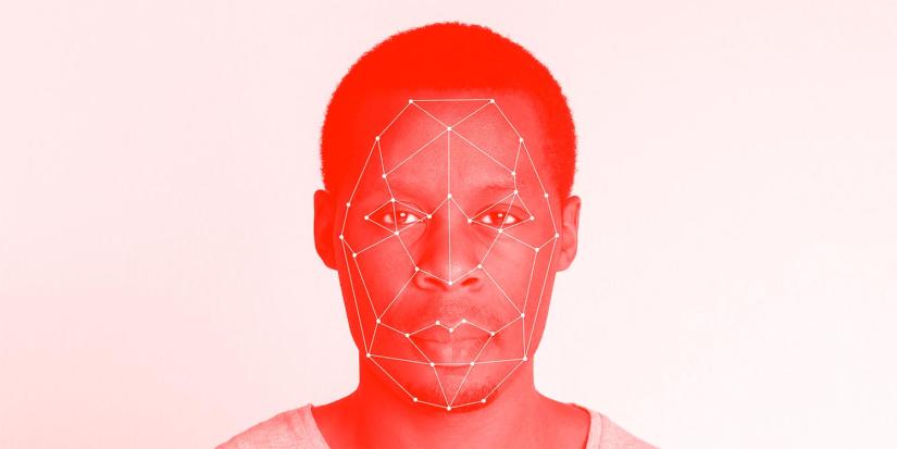 Dark skinned man facial recognition technology.
