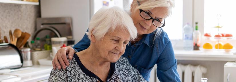 Elderly woman and daughter look at aged care options