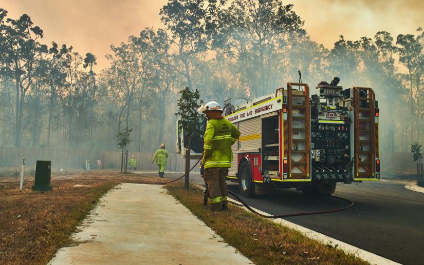 A fire crew in a bushfire affected suburban area