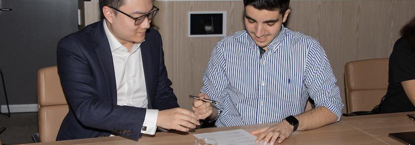 Jin Liu and Nour Al Hammouri signing the Student Partnership Agreement