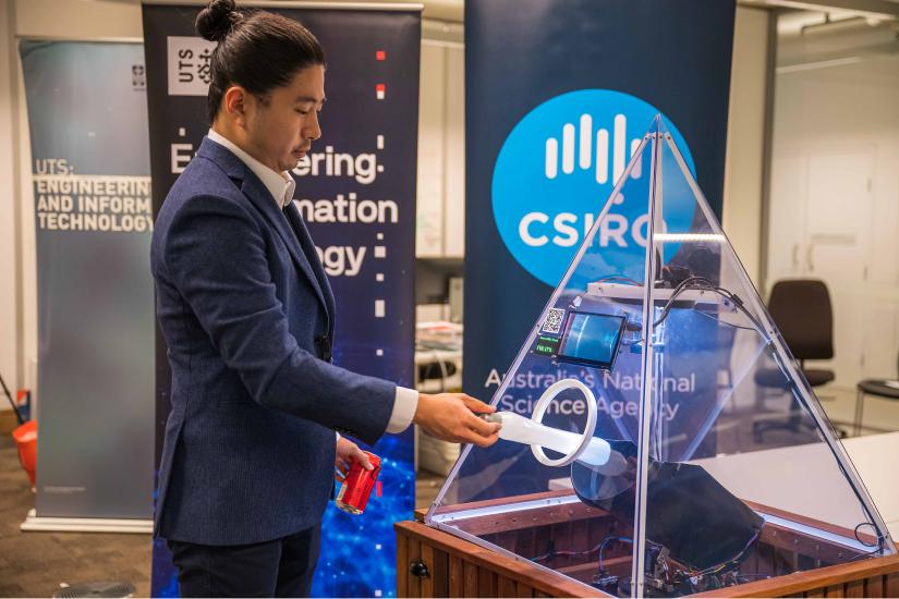 Dr Xu Wang tests the Smart Bin in the IoT lab at UTS.