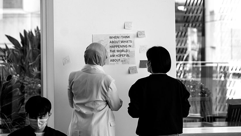 Two students looking at a poster