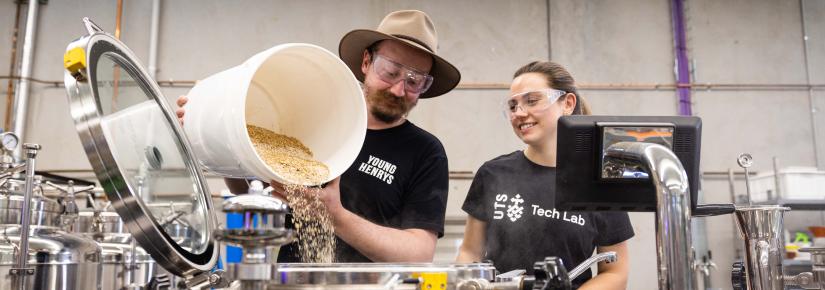 Young Henrys' Richard Adamson and UTS PhD student Laryssa Raffa pour ingredients into the Industry 4.0 brewery.