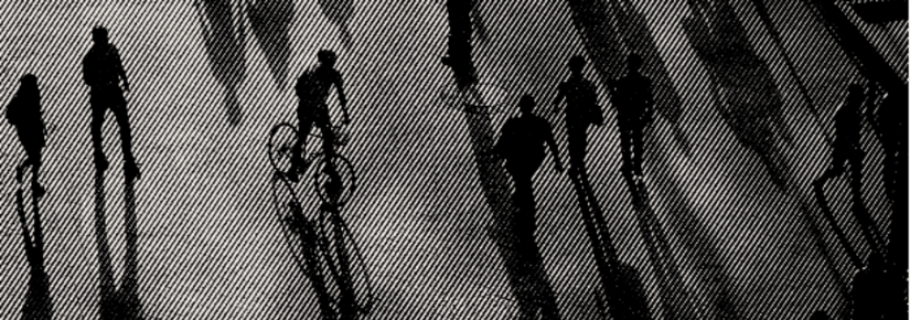 People walking, riding a bike in black and white