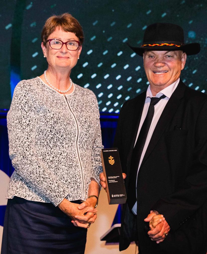 Jack Beetson standing with Chancellor at UTS Alumni Awards. He is wearing a black suit and tie, and wide brimmed black hat.