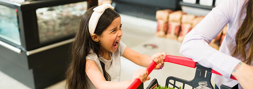 Stock picture of a young girl throwing a tantrum in a supermarket