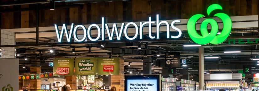 The entrance of a Woolworths supermarket with the signage prominently displayed.
