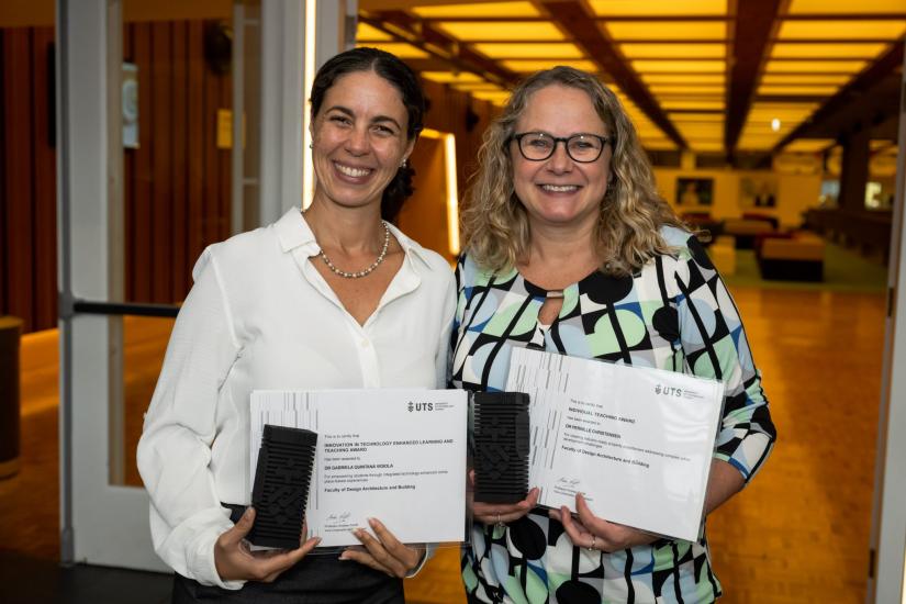 Dr Gabriella Quintana Vigil and Dr Pernille Christensen pose with certificates and trophies in interior space