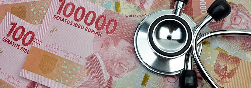 A stethoscope on top of Indonesian rupiah
