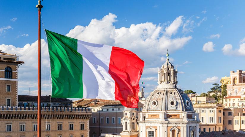Italian flag flying above buildings and cathedral