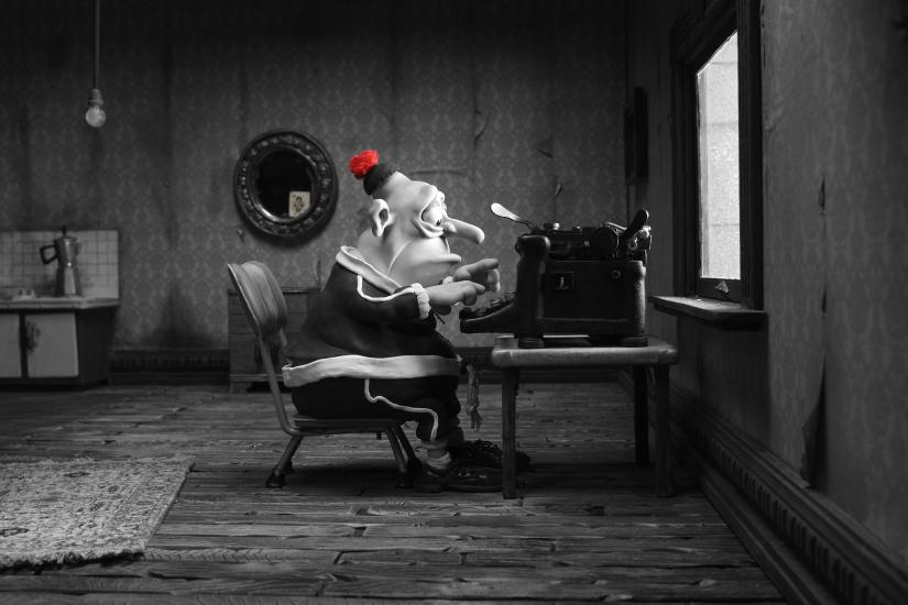 A still from 'Mary and Max', where Max sits at a typewriter, wearing a red hat