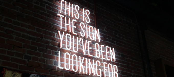 Neon light sign reading: this is the sign you've been looking for