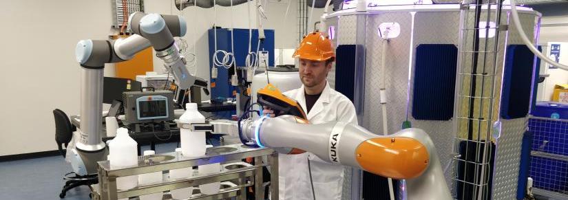Dr Marc Carmichael in the lab with cobots