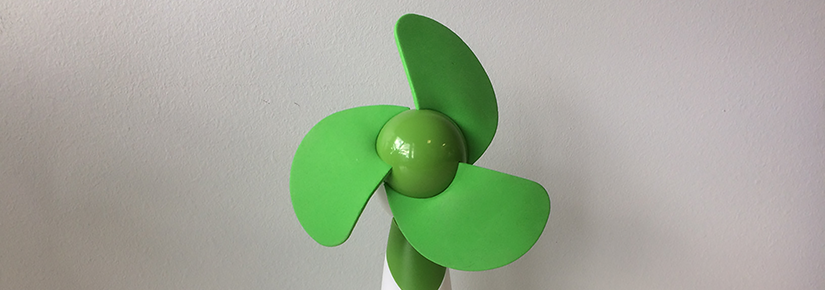 Hand-held fan with white handle and bright green blades