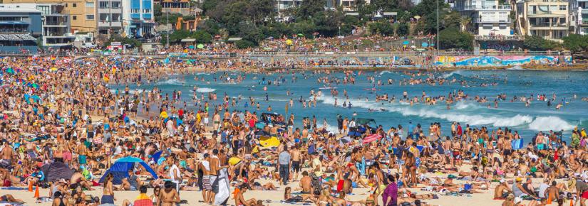 Very crowded but immensely popular Bondi Beach in Sydney. Thousands of sun lovers will gather here to swim and surf on any sunny day, tourists and locals alike.