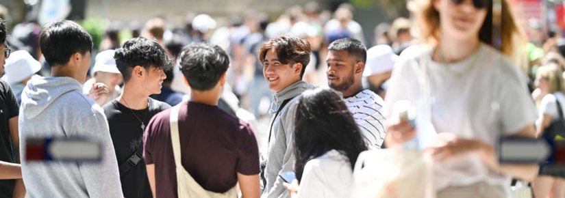 a group of smiling students looking at each other at UTS