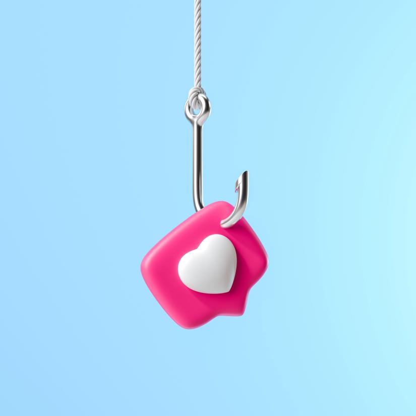 a fish hok hangs with a love heart icon staked on its tip