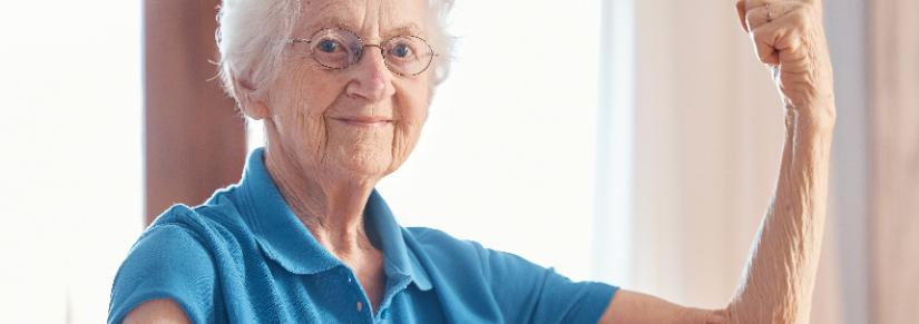 Elderly woman flexes arm muscles