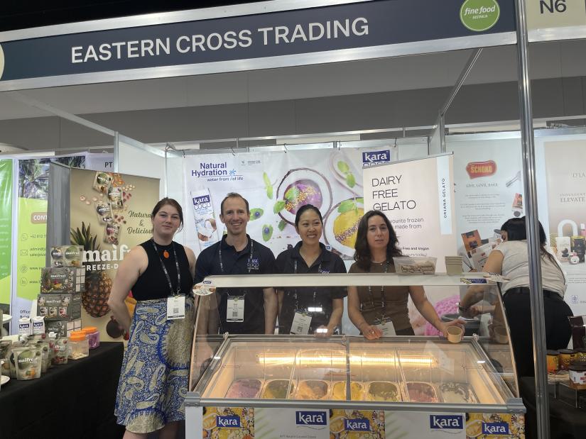 Four UTS students stand behind an ice-cream counter at a trade conference