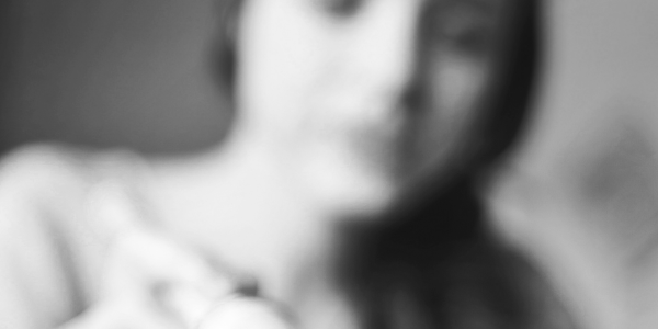 Black and white blurred image of a woman's face