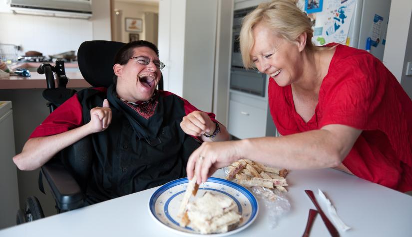 Photo of person with disability at mealtime with two models illustrating
