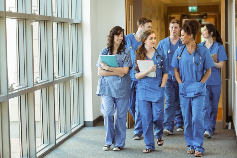 Medical students walk through corridor