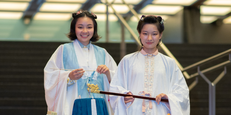 Two students dressed in traditional dress