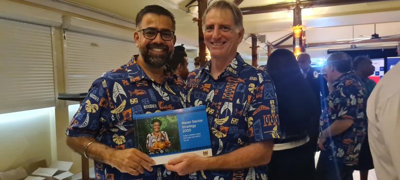 Pierre Mukheibir and Dr Amit Chanan holding the Water Sector Strategy for Fiji 2050