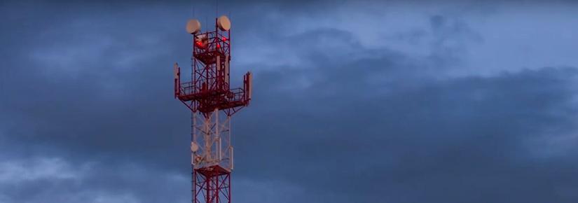 Screenshot from UTS video of a mobile phone tower against a cloudy sky