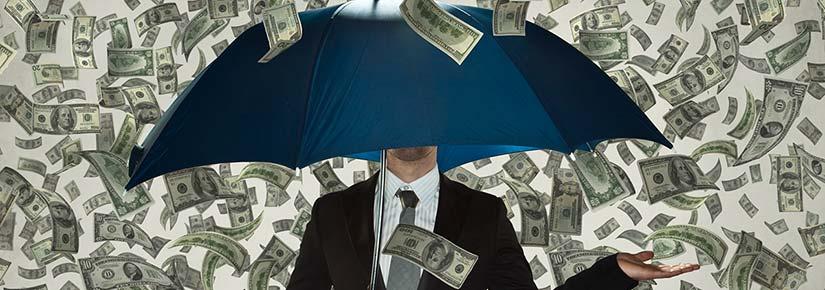 A suited person stands holding an umbrella, cash raining down around them