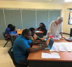 Lin Lock helping students in Vanuatu Workshop.