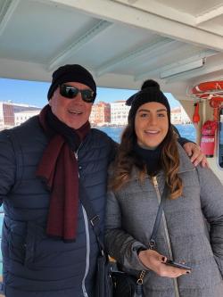 Chiara and her dad posing on a boat