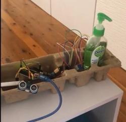 Arduino with ultrasonic sensor and bottle of hand sanitiser