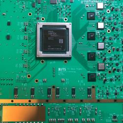 Top down view of a green motherboard which is part of high-speed real-time signal processing platform
