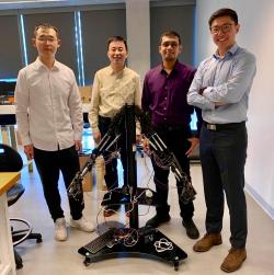 AI Exoskeleton Team members with robotic arms prototype. Li Wang, academic supervisor Steven Su, Jephil Palayil, and CTO Kairui Guo.