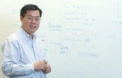 Professor Tuan Nguyen standing in front of a white board