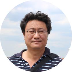 Professor Ying Zhang profile. Blue sky and clouds are in the background.
